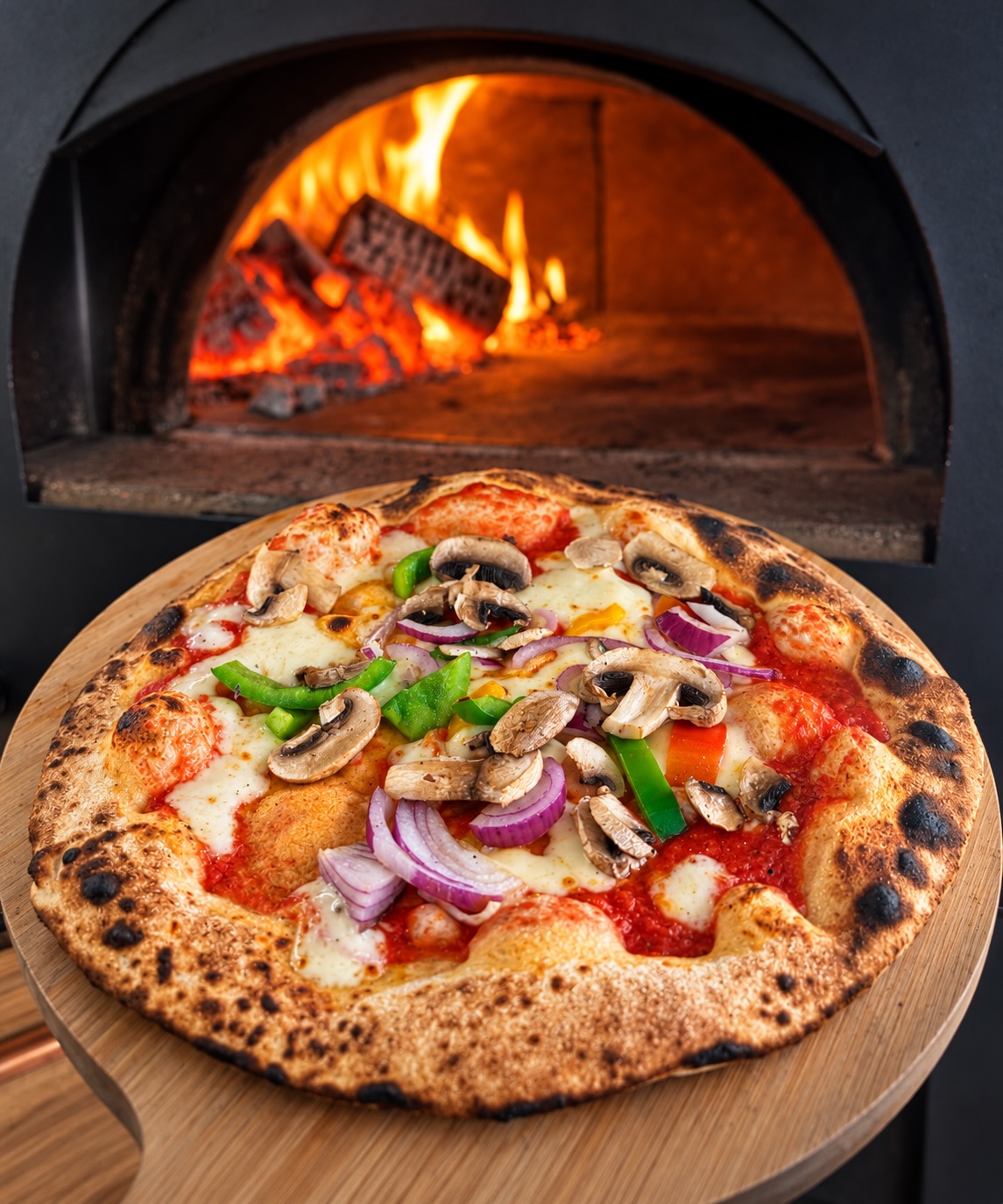 Fresh Wood-Fired Pizza, Cooked at Your Christmas Party in Staffordshire, Stoke-On-Trent, Cheshire Fresh wood-fired pizzas being served at a Christmas party